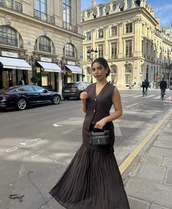 Detail of coffee brown knit vest with gold buttons and pleated long skirt set for women