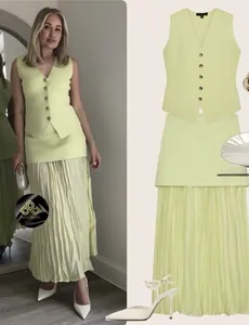 Detail of light green knit vest and pleated maxi skirt set with button-down front