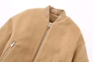 Detail of camel wool varsity jacket featuring ribbed collar and metallic zipper closure