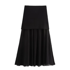 Detail of A-line black midi skirt featuring contrast pleated tulle hem and woven fabric