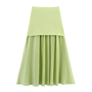 Detail of light green pleated maxi skirt with a seamless high-waist patchwork design