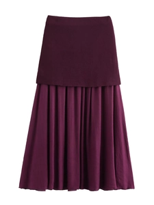 Detailed view of dark purple layered maxi skirt with knit fabric and pleated chiffon hem