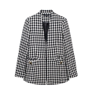 Detail of black and white houndstooth tweed jacket with vintage gold metal buttons