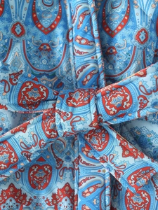 Détail de l'imprimé paisley et de la ceinture sur ce manteau réversible pour femme
