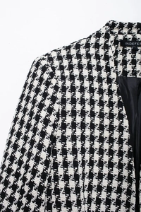 Close-up of black and white houndstooth tweed texture and premium satin lining