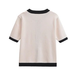 Detail of short sleeve knit top showing contrast ribbed collar and beige texture