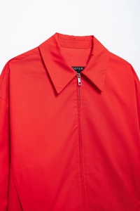 Detail of red zipper jacket collar with metal hardware and high-quality fabric texture