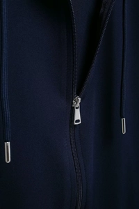 Detailed macro view of high-quality silver metal zipper and drawstring on navy blue jacket