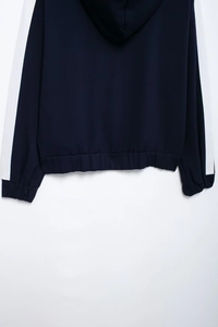 Detail of navy blue hoodie with white side stripes and elastic ribbed hemline