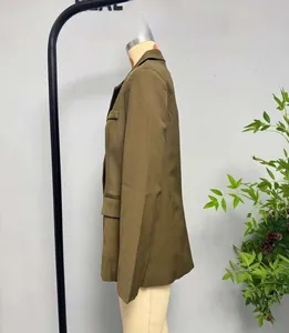 Detail shot of olive green structured blazer with notch lapels and flap pockets