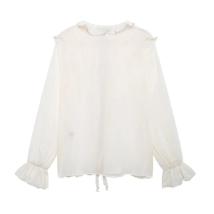 Detail of white chiffon shirt showing ruffled collar and decorative bow tie hem