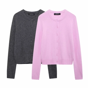 Detail view of dark grey and pink knit cardigans with single-breasted buttons and ribbed cuffs
