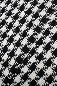 Close-up macro view of high-quality black and white houndstooth wool fabric texture