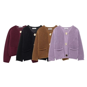 Detailed macro view of heavy knit cardigans with metal buttons in four vibrant colors
