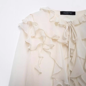 Elegant cream ruffled chiffon blouse with tie-up bow detail and tiered layers for women