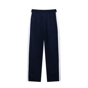 Detail of navy blue track pants with white side stripes and elastic waist for sporty look