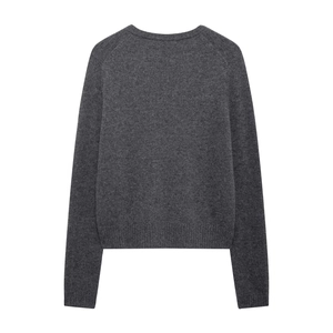 Detail view of the dark grey knit texture and ribbed hem on this casual crewneck sweater