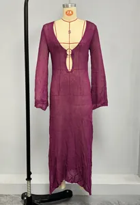 Detail of purple open knit maxi dress featuring a deep V-neck and metal ring hardware