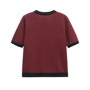 Rear view of a burgundy short-sleeve knit top with black ribbed edges on white background
