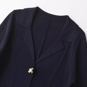 Women's navy knit cardigan jacket with elegant floral gold buttons and notched lapel