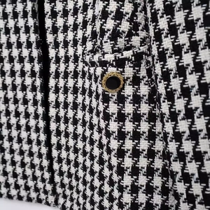French minimalist black and white houndstooth tweed jacket with gold textured buttons