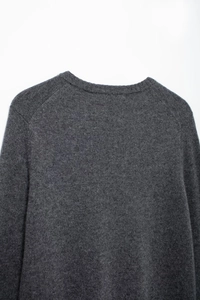 Close-up of knit sweater neck with ribbing and high-quality dark grey wool texture