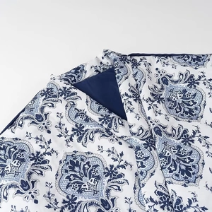 Blue paisley floral pattern duvet cover with solid navy reverse side and clean stitching