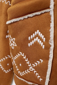 Detailed embroidery and plush faux shearling trim on a brown faux suede coat for women