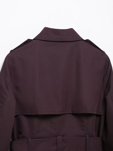 Detail view of a slim-fit trench coat back with epaulettes and refined stitching