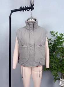 Detail view of grey quilted puffer vest featuring high collar and secure zip pockets