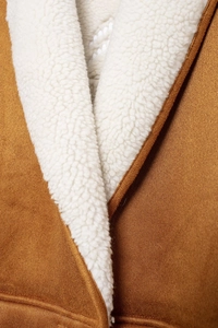 Detailed view of brown faux suede coat with white sherpa fleece lining and premium texture