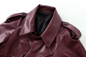 Detailed close-up of dark burgundy leather jacket with wide collar and shoulder epaulettes