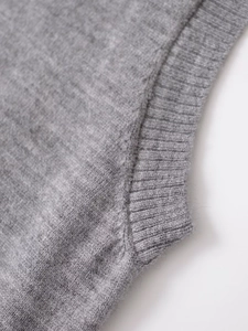 Close-up of gray knit vest showing ribbed round neck detail and soft textured fabric