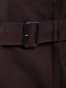 Detail view of burgundy trench coat belt with metallic buckle and reinforced eyelets
