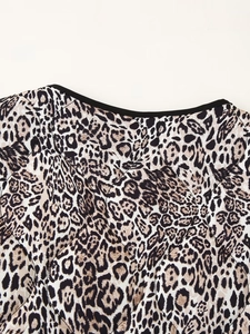Macro detail of leopard print jacket with diamond quilting and black round neckline