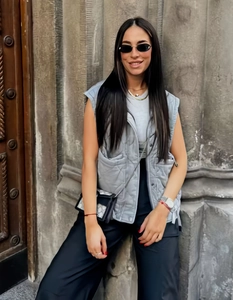Detailed close-up of light gray quilted sleeveless vest with large front pockets for women
