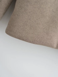 Macro detail of the high-quality camel wool fabric texture and soft rounded edges