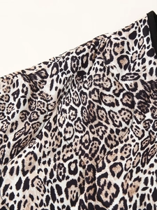 Close-up of leopard print quilted jacket showing diamond texture and black collar trim