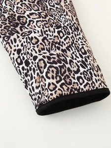 Detailed close-up of quilted leopard print sleeves with black piped cuffs on the jacket