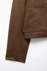 Detailed macro view showing the fine stitching and matte texture of the brown suede jacket