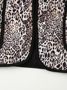 Detailed macro view of quilted leopard print jacket with high quality black fabric edging