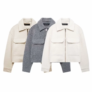 Detail view of cropped wool jackets with front zipper and flap pockets in neutral colors