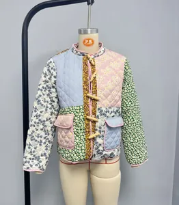 Detail view of floral patchwork quilted jacket featuring toggle buttons and stand collar
