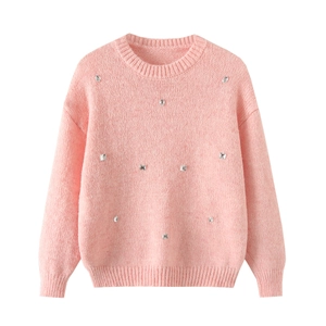 Close-up of pink crewneck sweater with silver metal stud details and ribbed knitting