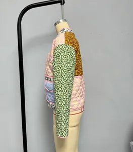 Close-up of quilted patchwork jacket with floral and striped patterns on a mannequin