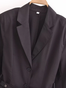 Detail of black blazer dress with notch lapel, button closure and size S label