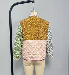 Rear view of a floral patchwork quilted jacket with pink trim and stand-up collar