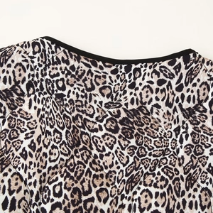 Women's leopard print quilted coat with round neck and chic black trim detailing