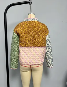 Detail view of women's patchwork quilted jacket featuring floral patterns and diamond stitching