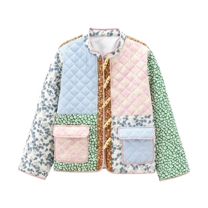 Close-up of quilted patchwork jacket with floral patterns and wooden horn buttons